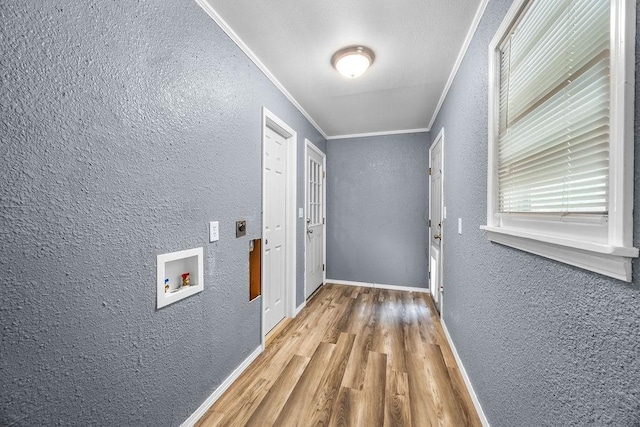 713 Young St, Springdale, AR 72764 - hallway with a textured wall, crown molding, wood finished floors, and baseboards