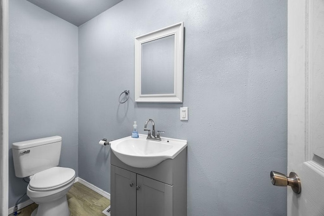 713 Young St, Springdale, AR 72764 - half bath featuring vanity, toilet, wood finished floors, and baseboards
