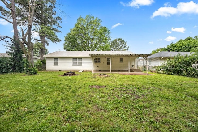 713 Young St, Springdale, AR 72764 - back of house featuring a lawn, metal roof, crawl space, and a patio