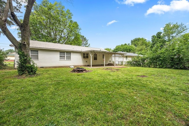 713 Young St, Springdale, AR 72764 - back of property featuring a patio, a fire pit, a yard, and crawl space