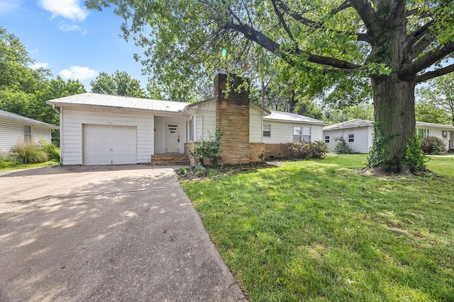 713 Young St, Springdale, AR 72764 - view of front facade featuring a chimney, an attached garage, a front lawn, concrete driveway, and metal roof