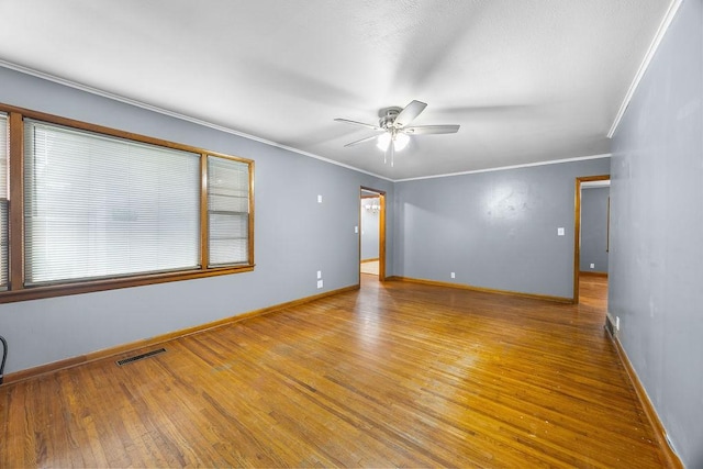 713 Young St, Springdale, AR 72764 - spare room with a ceiling fan, wood finished floors, baseboards, and crown molding