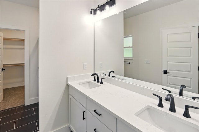 4545 Gibson St, Springdale, AR 72762 - full bathroom with double vanity, a spacious closet, and baseboards