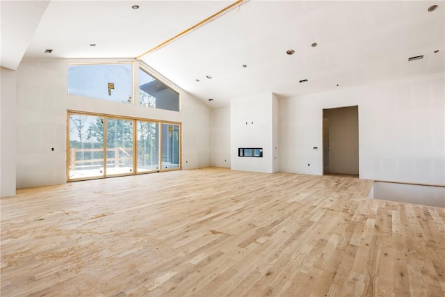 15903 Hawks Landing Dr, Rogers, AR 72756 - unfurnished living room featuring wood finished floors, high vaulted ceiling, and a glass covered fireplace