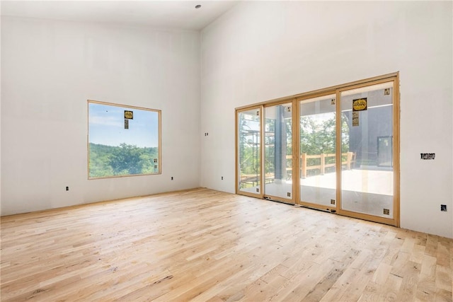 15903 Hawks Landing Dr, Rogers, AR 72756 - unfurnished room featuring healthy amount of natural light, wood finished floors, and a towering ceiling