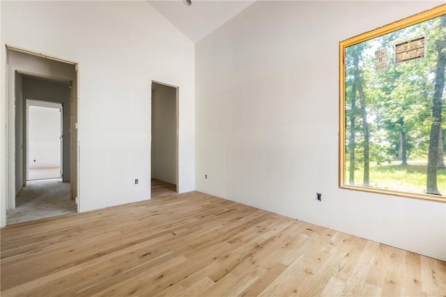 15903 Hawks Landing Dr, Rogers, AR 72756 - spare room featuring wood finished floors and high vaulted ceiling