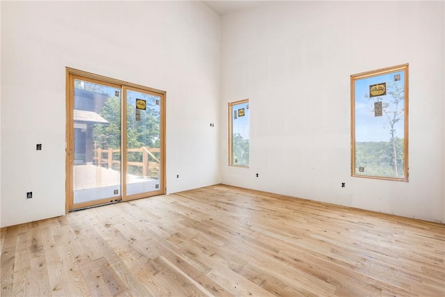 15903 Hawks Landing Dr, Rogers, AR 72756 - empty room with wood finished floors and a towering ceiling