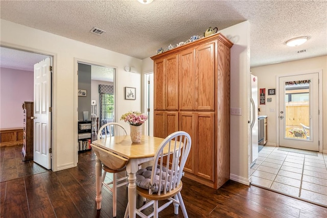 14 Jordan Ln, Bentonville, AR 72712 - dining room with dark wood-style floors and a textured ceiling