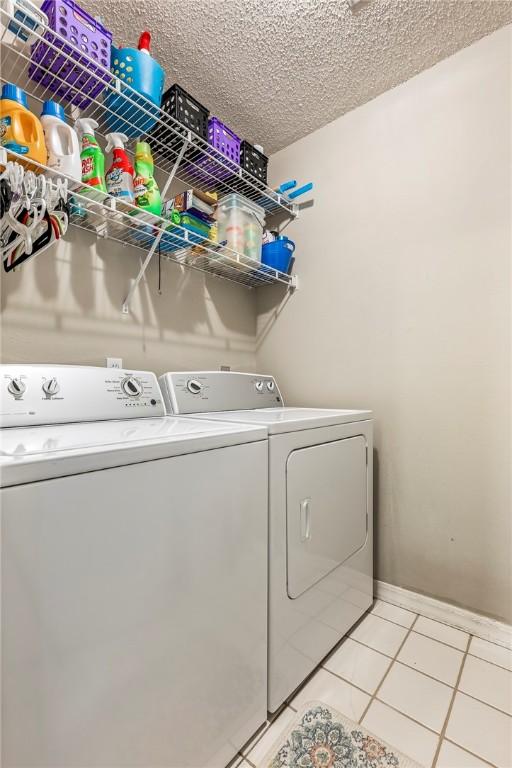 14 Jordan Ln, Bentonville, AR 72712 - washroom featuring independent washer and dryer and light tile patterned floors