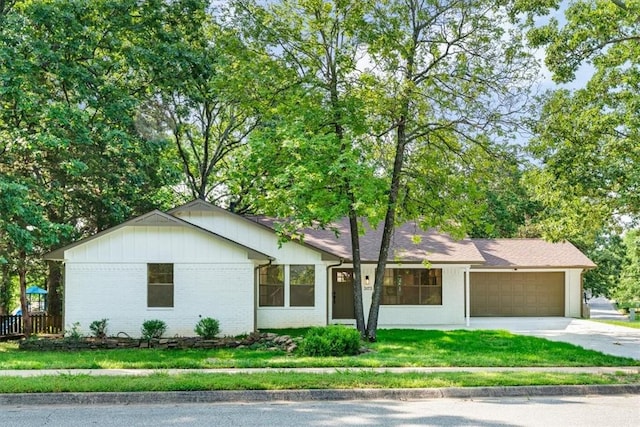 3173 N Katherine Ave, Fayetteville, AR 72703 - ranch-style house with a garage, driveway, a front yard, brick siding, and board and batten siding
