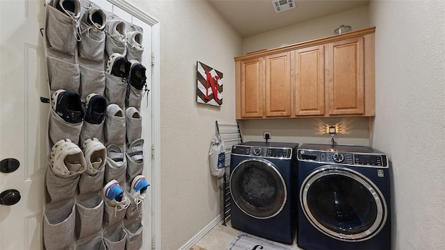 1051 Thornridge Rd, Bentonville, AR 72713 - laundry room featuring independent washer and dryer, cabinet space, light tile patterned floors, and baseboards