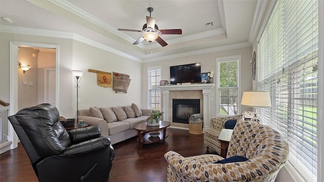 1051 Thornridge Rd, Bentonville, AR 72713 - living area featuring wood finished floors, a tile fireplace, a ceiling fan, ornamental molding, and a raised ceiling