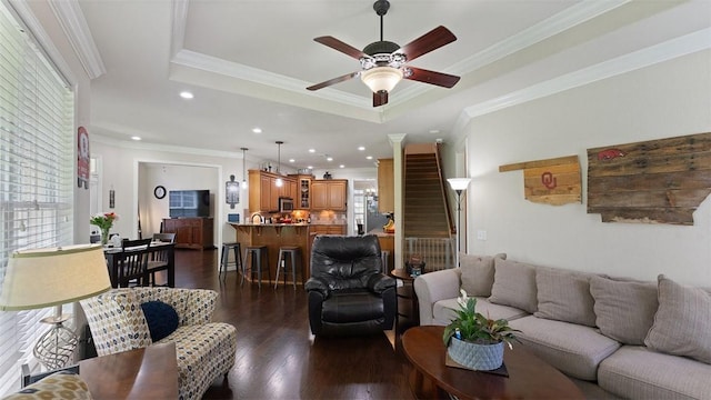 1051 Thornridge Rd, Bentonville, AR 72713 - living room featuring crown molding, a ceiling fan, dark wood finished floors, a tray ceiling, and stairway