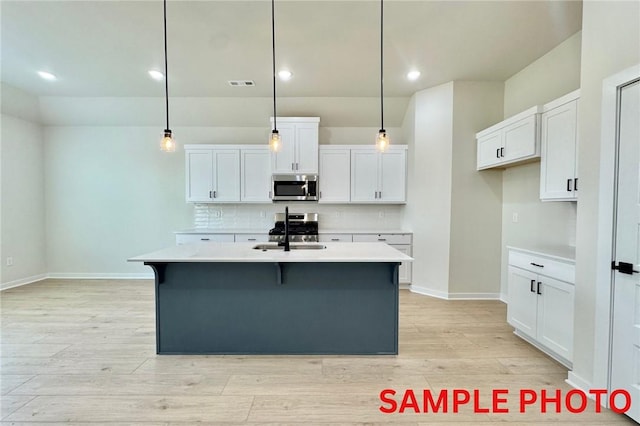 5902 SW Desert Ave, Bentonville, AR 72713 - kitchen featuring stainless steel microwave, a sink, light countertops, backsplash, and white cabinets