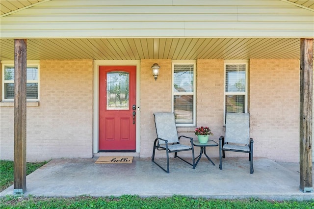 1630 S Dixieland Rd, Rogers, AR 72758 - doorway to property featuring covered porch and brick siding