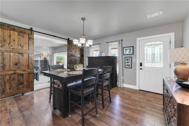 1630 S Dixieland Rd, Rogers, AR 72758 - dining area with dark wood-type flooring, a chandelier, baseboards, and a barn door