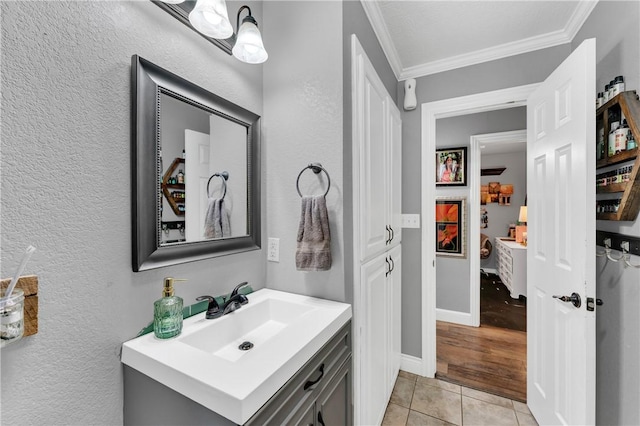1630 S Dixieland Rd, Rogers, AR 72758 - bathroom with ornamental molding, vanity, a textured wall, and tile patterned flooring