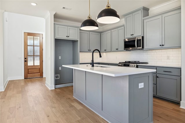 10 Rushden Ln, Bella Vista, AR 72714 - kitchen with stainless steel microwave, gray cabinetry, range, a sink, and baseboards