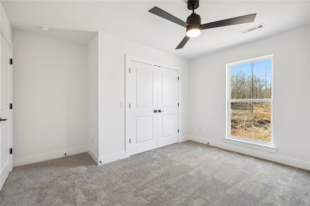 10 Rushden Ln, Bella Vista, AR 72714 - unfurnished bedroom with carpet flooring, baseboards, a closet, and a ceiling fan