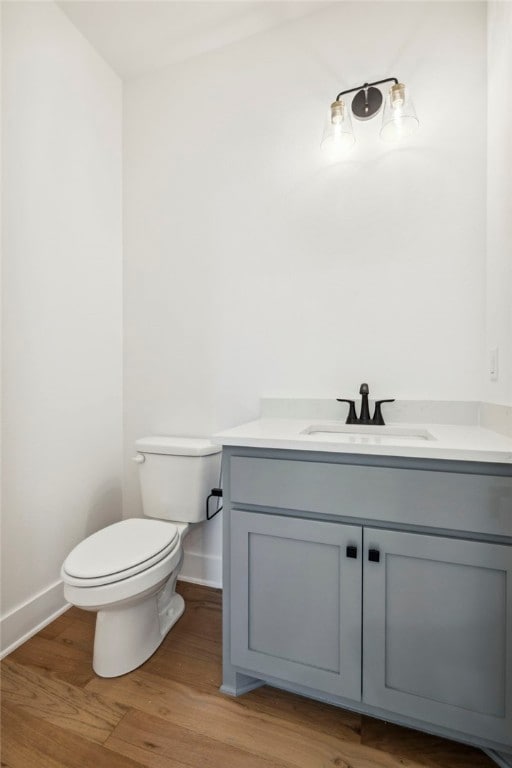 10 Rushden Ln, Bella Vista, AR 72714 - half bath with vanity, toilet, baseboards, and wood finished floors