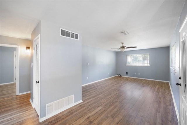 907 S Ithaca Ave, Russellville, AR 72801 - unfurnished room featuring a ceiling fan, wood finished floors, and baseboards