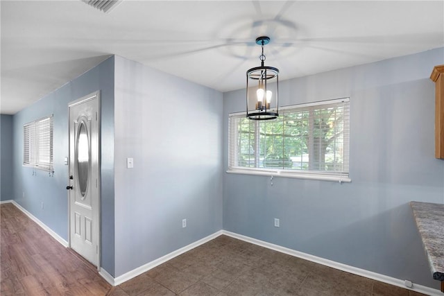 907 S Ithaca Ave, Russellville, AR 72801 - spare room with baseboards and a chandelier