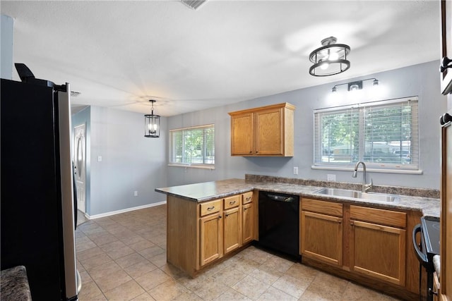 907 S Ithaca Ave, Russellville, AR 72801 - kitchen with black appliances, a peninsula, a sink, and brown cabinetry