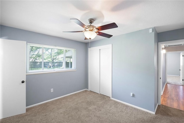 907 S Ithaca Ave, Russellville, AR 72801 - unfurnished bedroom with carpet flooring, a closet, baseboards, and a ceiling fan