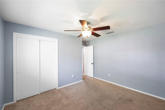 907 S Ithaca Ave, Russellville, AR 72801 - unfurnished bedroom featuring carpet floors, a closet, and a ceiling fan