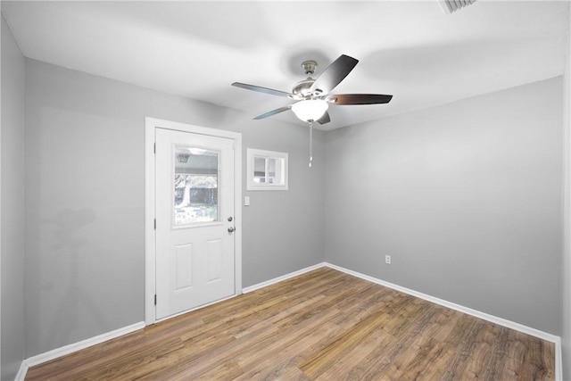 907 S Ithaca Ave, Russellville, AR 72801 - spare room with wood finished floors, a ceiling fan, and baseboards