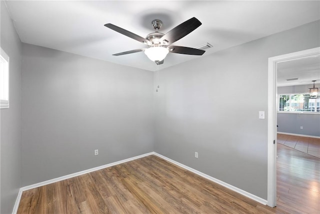 907 S Ithaca Ave, Russellville, AR 72801 - empty room with wood finished floors and ceiling fan