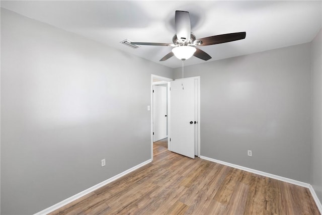 907 S Ithaca Ave, Russellville, AR 72801 - unfurnished room with a ceiling fan, baseboards, and wood finished floors