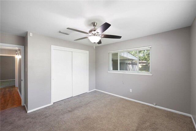 907 S Ithaca Ave, Russellville, AR 72801 - unfurnished bedroom with a closet, carpet flooring, baseboards, and a ceiling fan