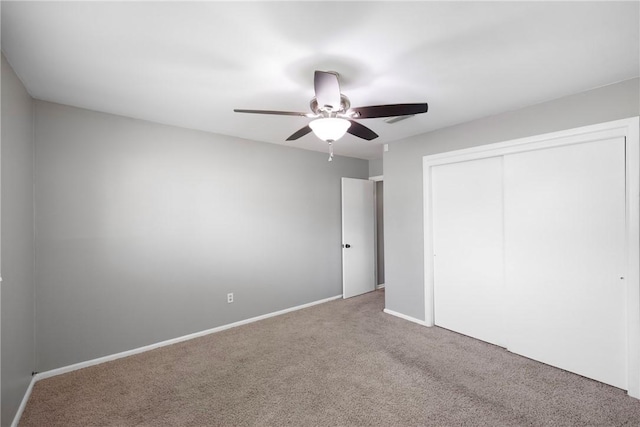 907 S Ithaca Ave, Russellville, AR 72801 - unfurnished bedroom with carpet flooring, a closet, baseboards, and ceiling fan