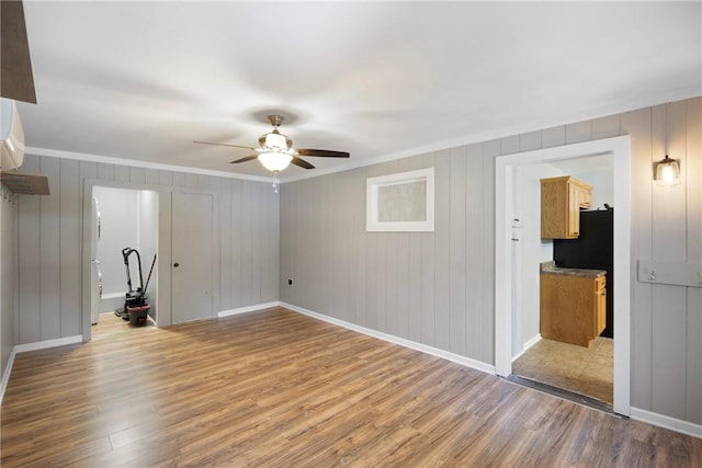 907 S Ithaca Ave, Russellville, AR 72801 - unfurnished living room featuring a ceiling fan, wood finished floors, crown molding, and baseboards