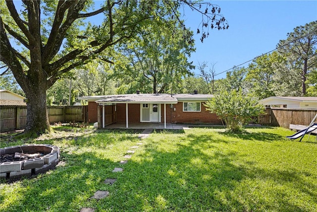 907 S Ithaca Ave, Russellville, AR 72801 - rear view of property with brick siding, a patio area, a fire pit, and a chimney