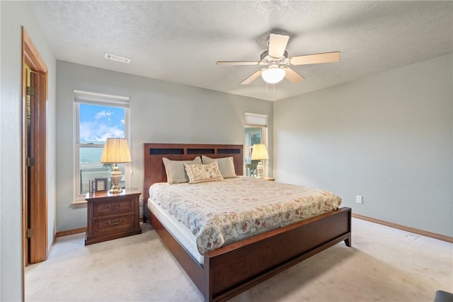 74 Twin Peak Dr, Holiday Island, AR 72631 - bedroom with light carpet, baseboards, a textured ceiling, and a ceiling fan
