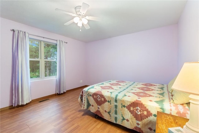 74 Twin Peak Dr, Holiday Island, AR 72631 - bedroom with wood finished floors, baseboards, and ceiling fan