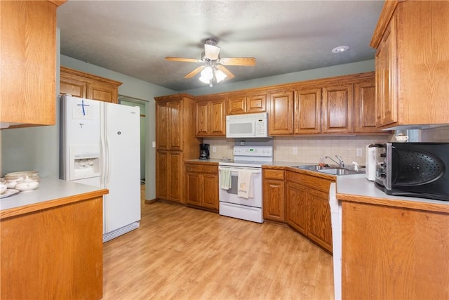 74 Twin Peak Dr, Holiday Island, AR 72631 - kitchen featuring white appliances, a sink, a ceiling fan, brown cabinetry, and decorative backsplash