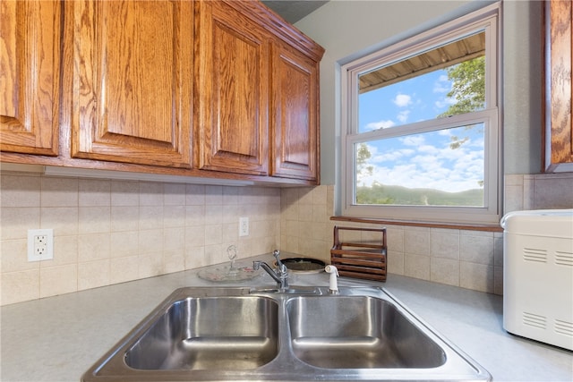 74 Twin Peak Dr, Holiday Island, AR 72631 - kitchen featuring a sink, brown cabinets, light countertops, and tasteful backsplash
