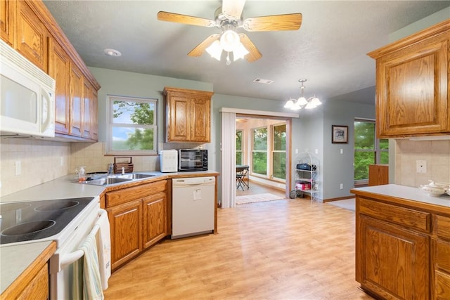 74 Twin Peak Dr, Holiday Island, AR 72631 - kitchen featuring white appliances, backsplash, light wood-style flooring, and healthy amount of natural light