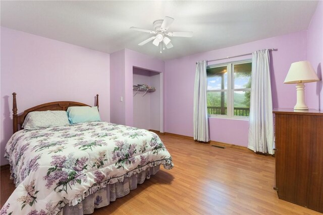 74 Twin Peak Dr, Holiday Island, AR 72631 - bedroom featuring light wood finished floors, a ceiling fan, baseboards, and a closet