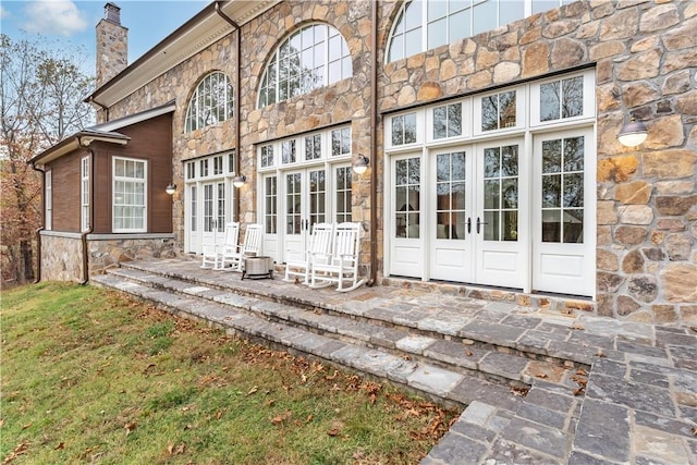10760 Sugar Creek Rd, Bentonville, AR 72751 - rear view of house with french doors, stone siding, a chimney, and a patio