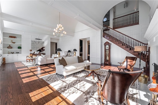 10760 Sugar Creek Rd, Bentonville, AR 72751 - living room featuring hardwood / wood-style flooring, stairway, built in features, ornamental molding, and a chandelier