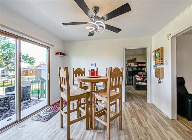 103 Mockingbird St, Harrison, AR 72601 - dining area featuring light wood finished floors, a ceiling fan, and a textured ceiling