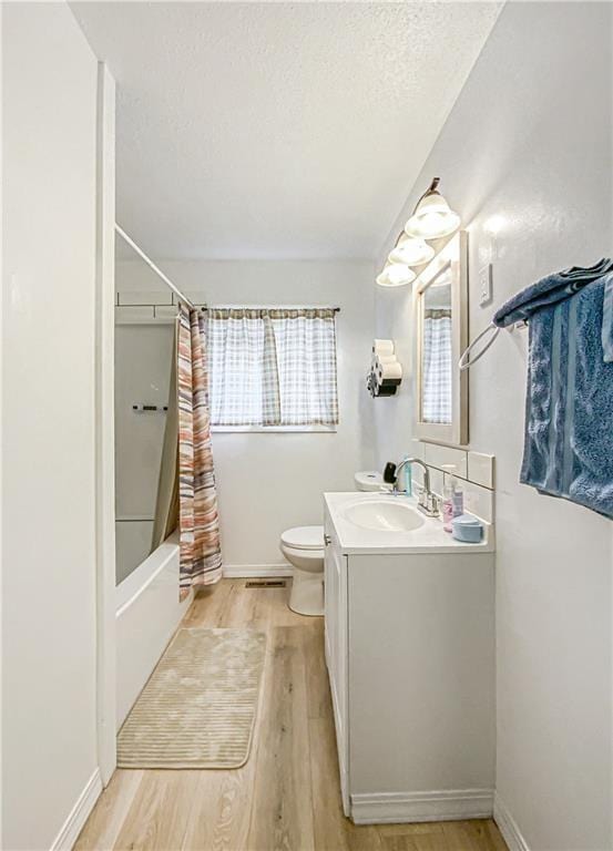 103 Mockingbird St, Harrison, AR 72601 - full bath with toilet, wood finished floors, vanity, shower / tub combo with curtain, and baseboards