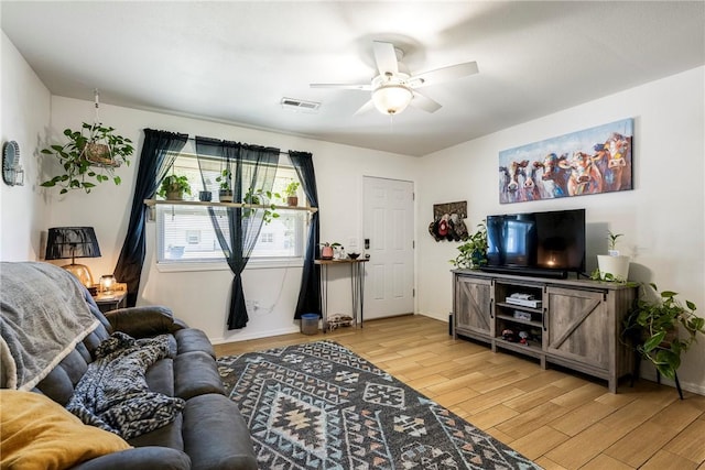 909 11th St, Bentonville, AR 72712 - living room with light wood-style flooring, ceiling fan, and baseboards