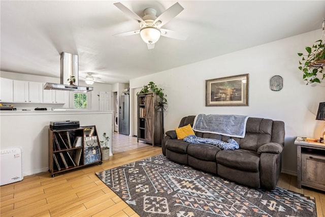 909 11th St, Bentonville, AR 72712 - living room with ceiling fan and light wood-style floors