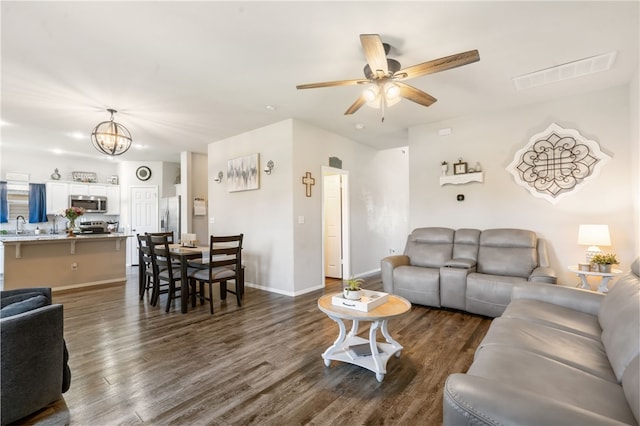 5003 W Claxton Cir, Fayetteville, AR 72704 - living area with ceiling fan, dark wood-style flooring, a chandelier, and baseboards