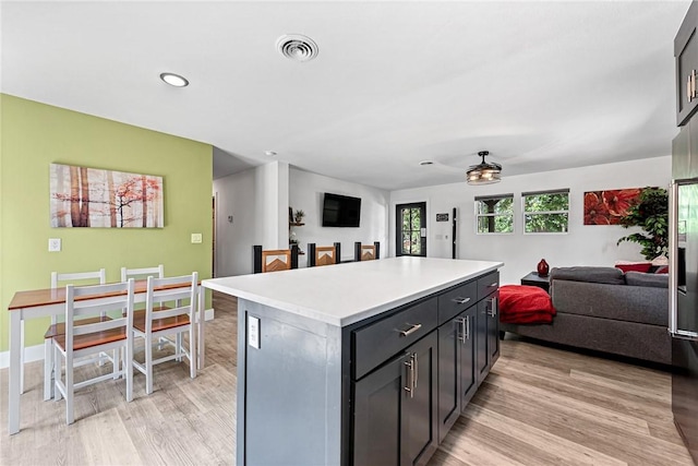 312 NW J St, Bentonville, AR 72712 - kitchen featuring open floor plan, light wood-style flooring, a center island, a ceiling fan, and recessed lighting